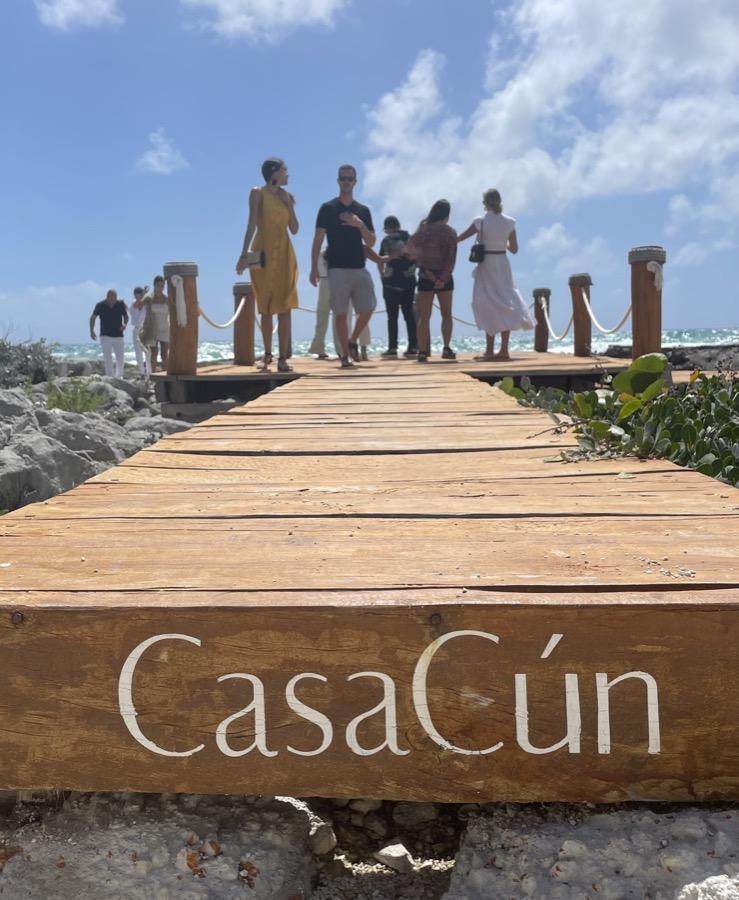 People gathering on the seaside walkway at CasaCún